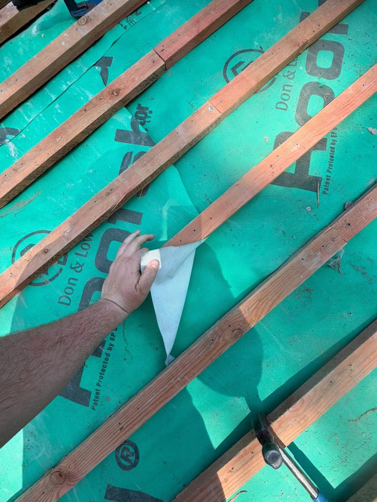 Contractors installing roof membrane near Shepton Mallet