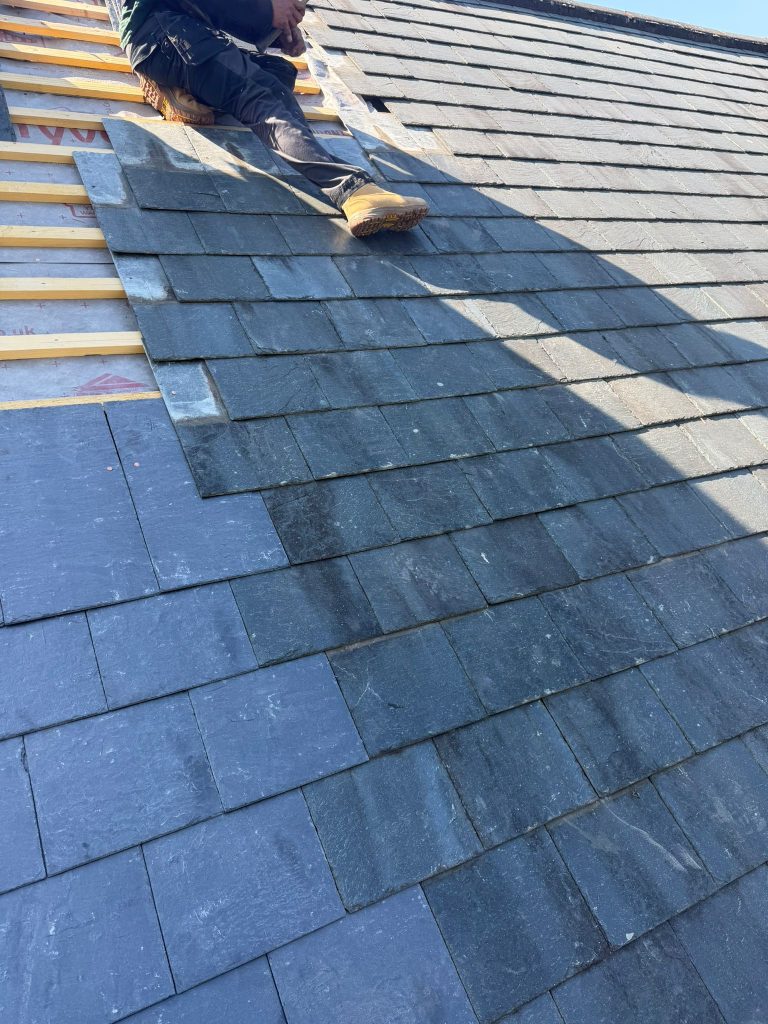 Installing slate tiles on a roof in Oakhill