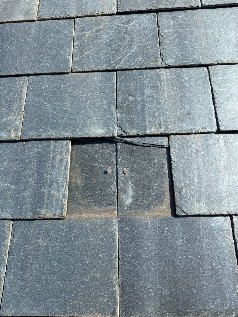 A broken Slate roof that needs repairing