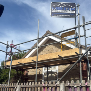 A house with scaffolding being repaired by mendip roofing contractors