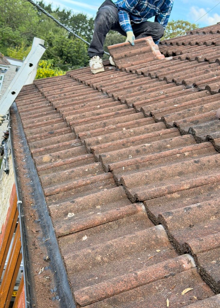Removing old roof tiles ready for replacement
