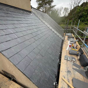A slate roof with scaffolding attached during repairs